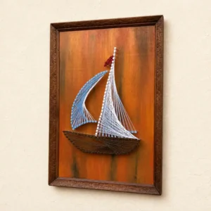 Framed string-art sailboat mounted on an orange-brown background