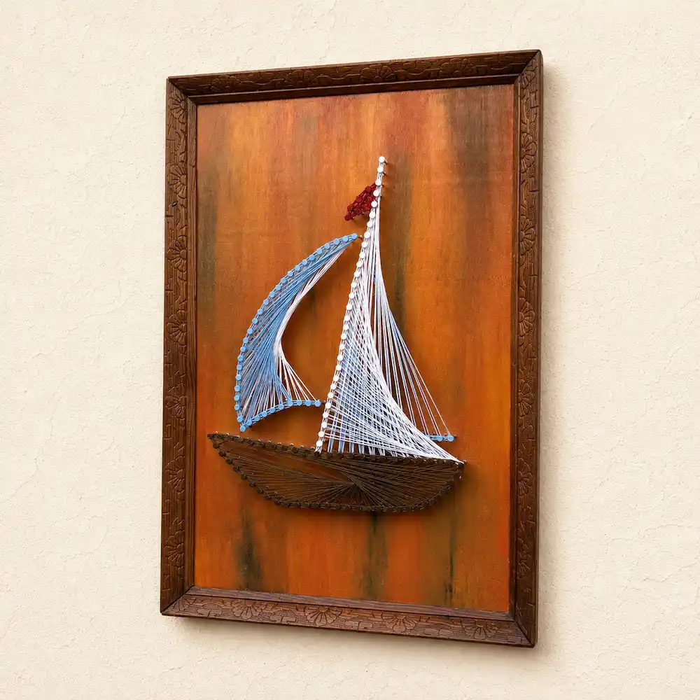 boat thread art - Artoza Crafts | Where Craft Becomes Style Framed string-art sailboat mounted on an orange-brown background