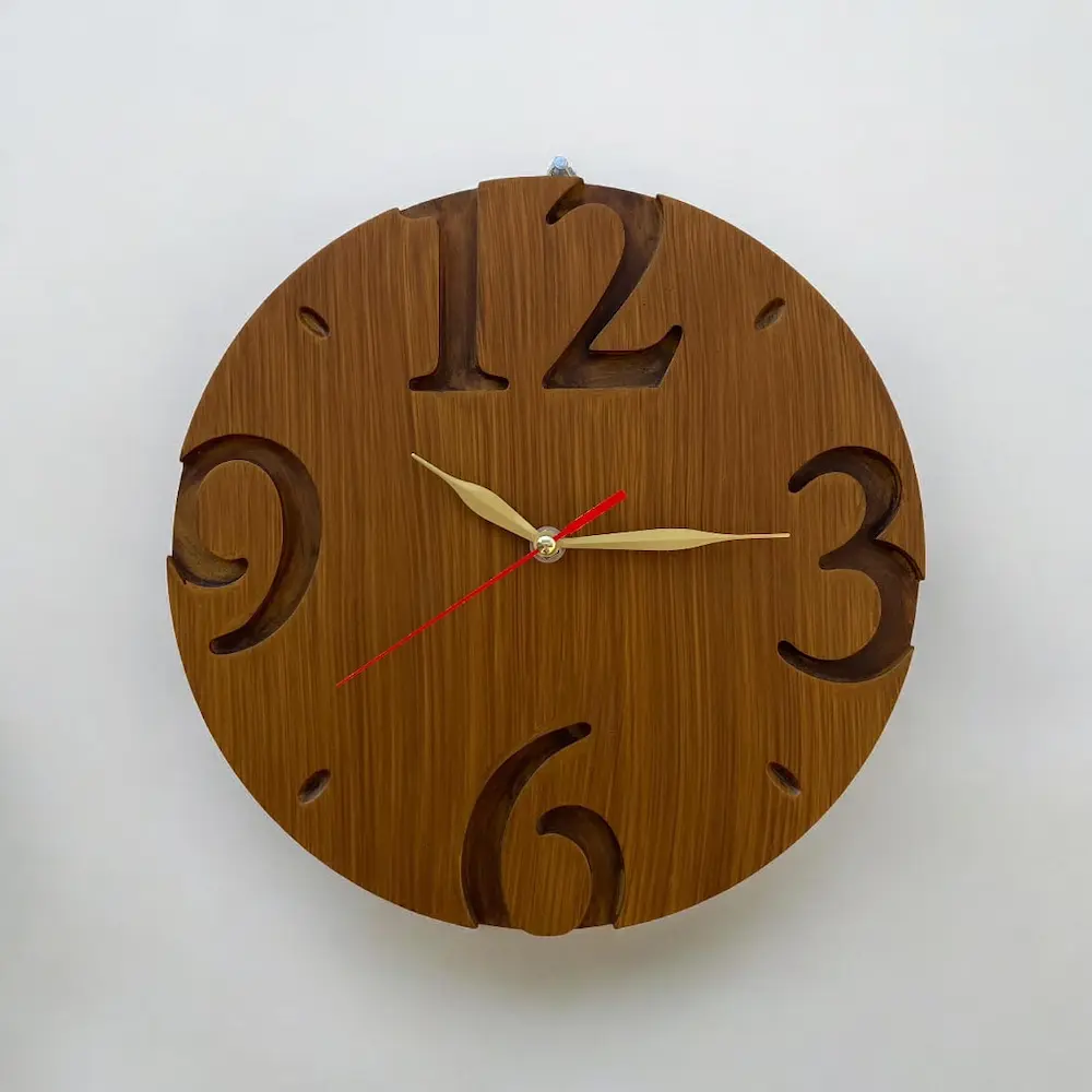 cnc round clock - Artoza Crafts | Where Craft Becomes Style Wooden round wall clock with oversized carved numerals 12, 3, 6, 9 and gold hour/minute hands with a red second hand.