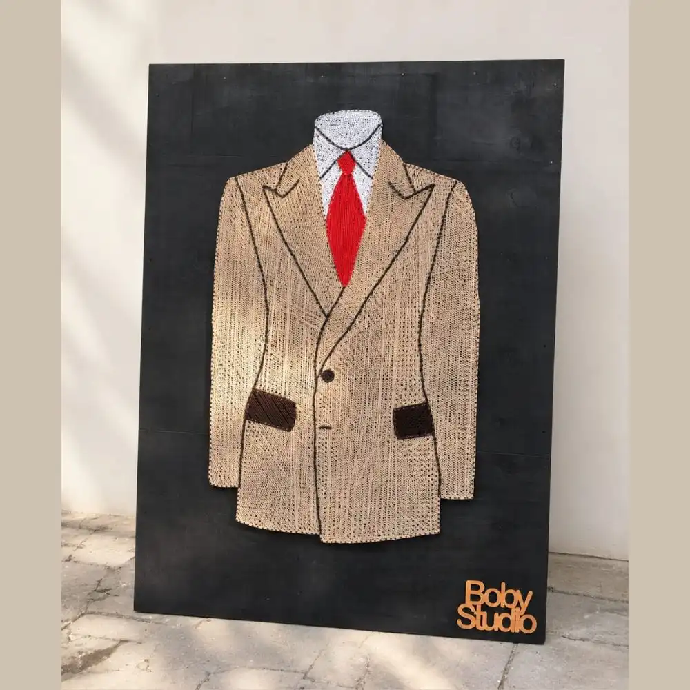 coat string art - Artoza Crafts | Where Craft Becomes Style Textured beige blazer with a red tie on a white shirt, mounted on a black background; 'Baby Studio' logo in bottom-right corner.