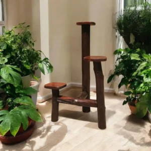 Wooden cat tree with three small platforms in a plant-filled living room.