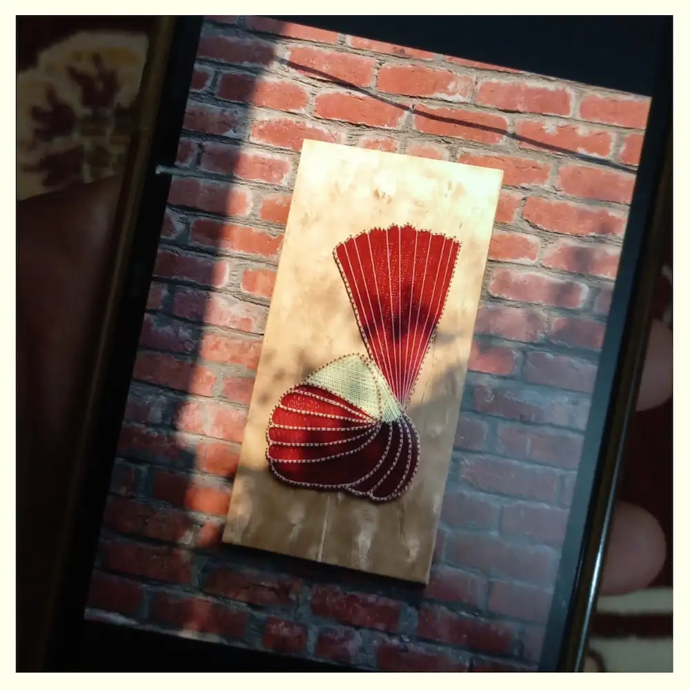groom turban - Artoza Crafts | Where Craft Becomes Style Red string-art panel featuring two shell-like shapes on a light wood plaque against a brick wall backdrop