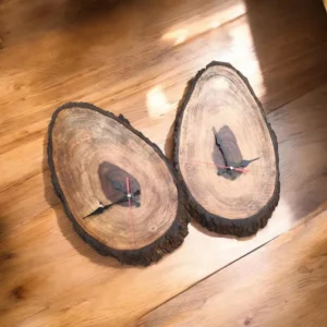 Two cross‑section tree slices repurposed as clocks with black hour/minute hands and red second hands on a wooden floor edge-wise.