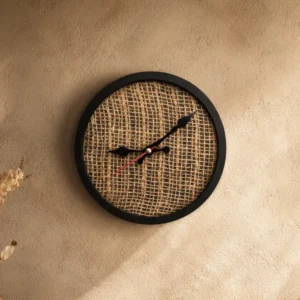 Round wall clock with a black frame and burlap-textured center, showing time around 4:40.