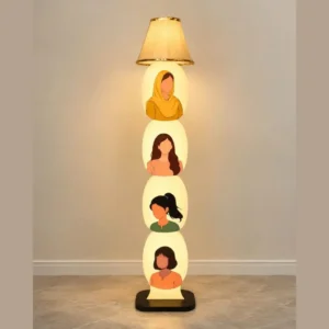 Tall stacked lamp with illuminated circular panels each showing a silhouetted woman portrait, decorative floor sculpture in a neutral room.