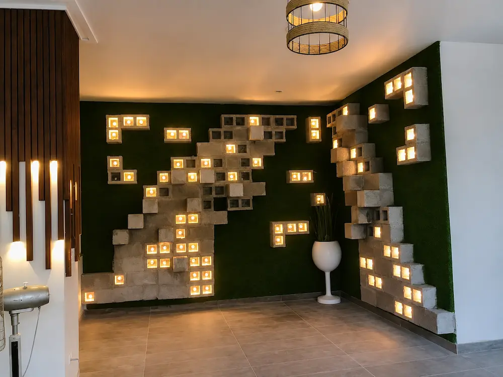 Warm LED lighting installed and tested inside the sculptural concrete block feature wall before the final styling of the private dining room.